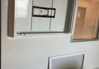 Proenc's anti-ligature TV enclosure sloped top being installed in a behavioral health unit