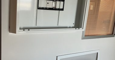 Proenc's anti-ligature TV enclosure sloped top being installed in a behavioral health unit